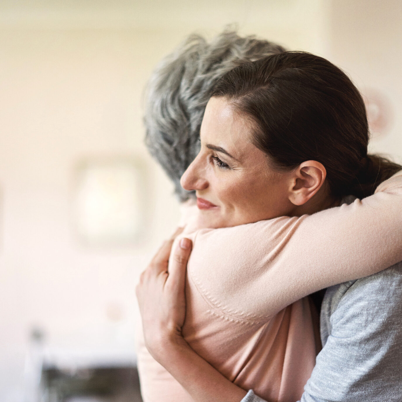 Every patient requires comforting attention Shot of a young nurse hugging a senior woman in a retirement home